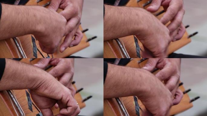 音乐家演奏竖琴的手的特写。