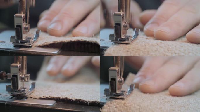 特写男人的手用缝纫机上的粗麻布缝制。手工服装工业概念。4k视频