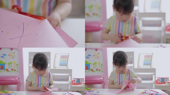 年轻女孩用剪刀剪纸制作纸艺