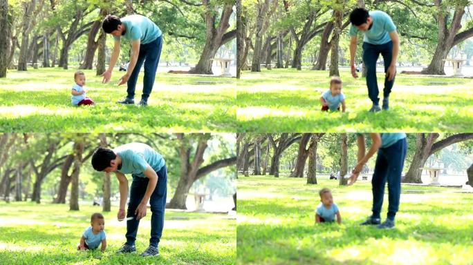 爸爸教儿子走路，公园，自然。在草地上行走。父子