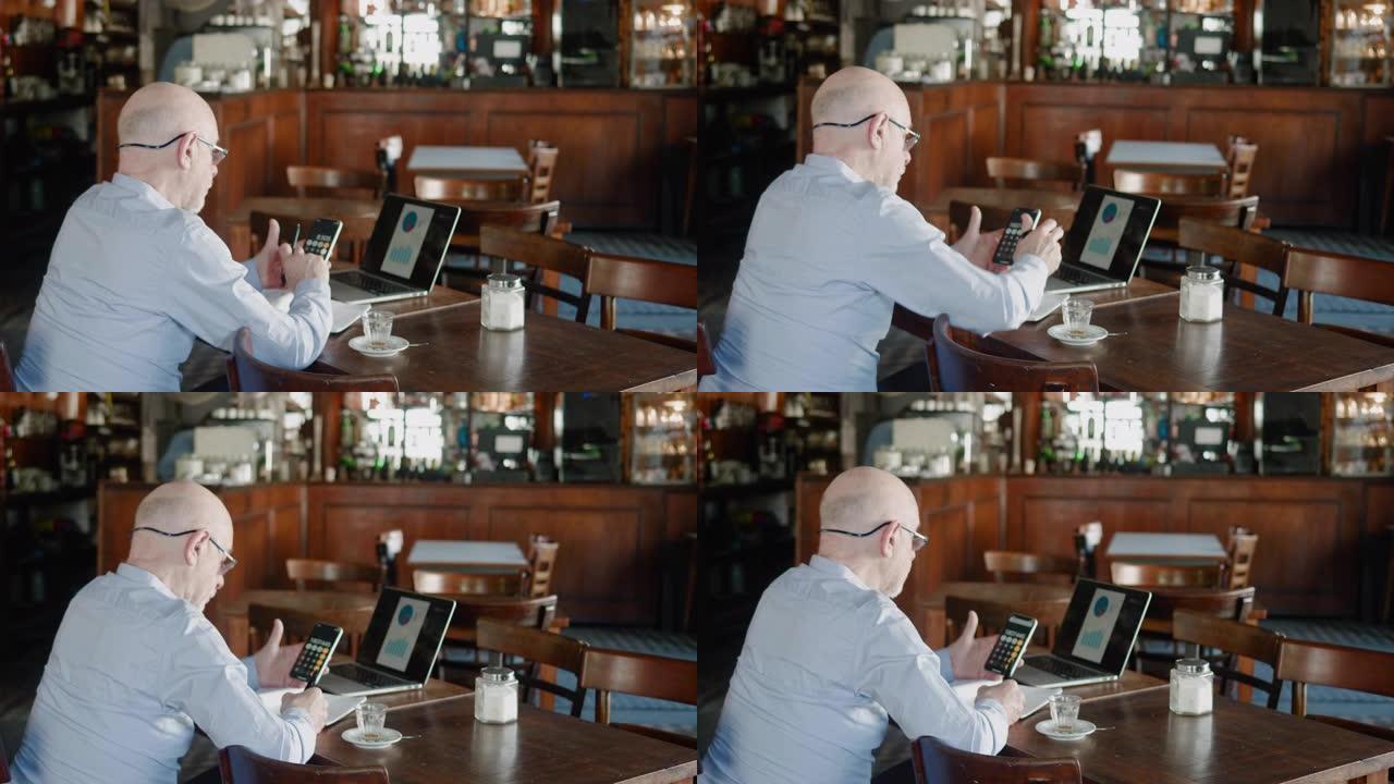 阿根廷高级企业主在餐厅用智能手机计算