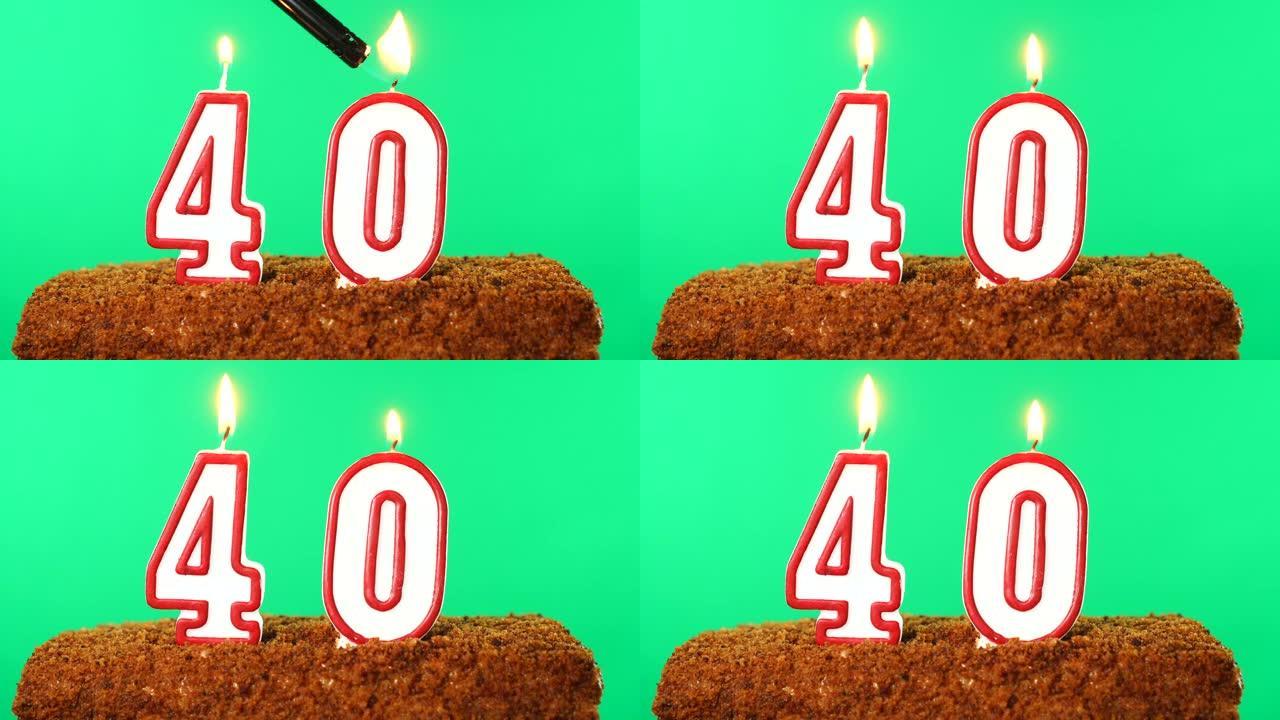 40号点燃蜡烛的蛋糕。色度键。绿屏。隔离