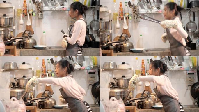 亚洲女孩穿着围裙，在家自己做薯条，生活理念。