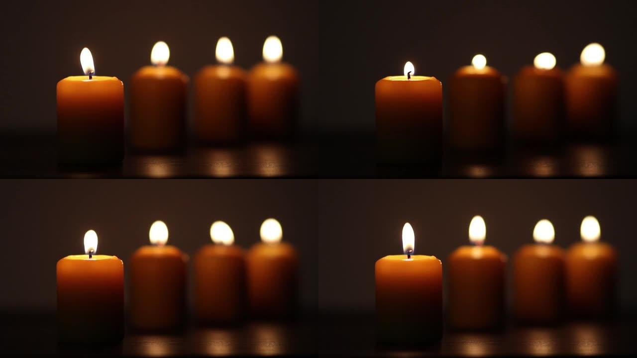 点燃的蜡烛，闪烁的火焰在黑暗中燃烧