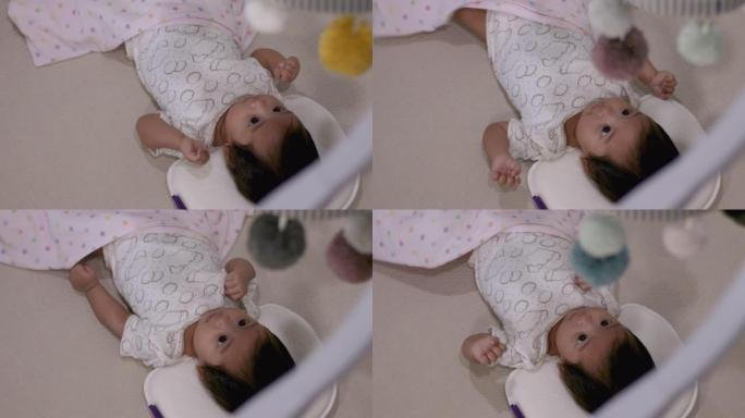 4k亚洲婴儿婴儿独自躺在家里，粉红色的毯子，相机通过天花板移动悬挂，舒适的卧室，儿童护理，白天，只有
