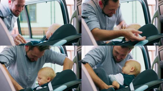特写男婴，坐在家用汽车内的婴儿汽车座椅上。门打开，他微笑着的大胡子父亲解开安全带，小心翼翼地把婴儿从