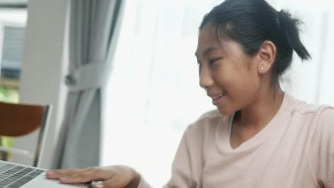 亚洲女孩在新型冠状病毒肺炎期间与朋友和老师在课堂上进行视频会议。