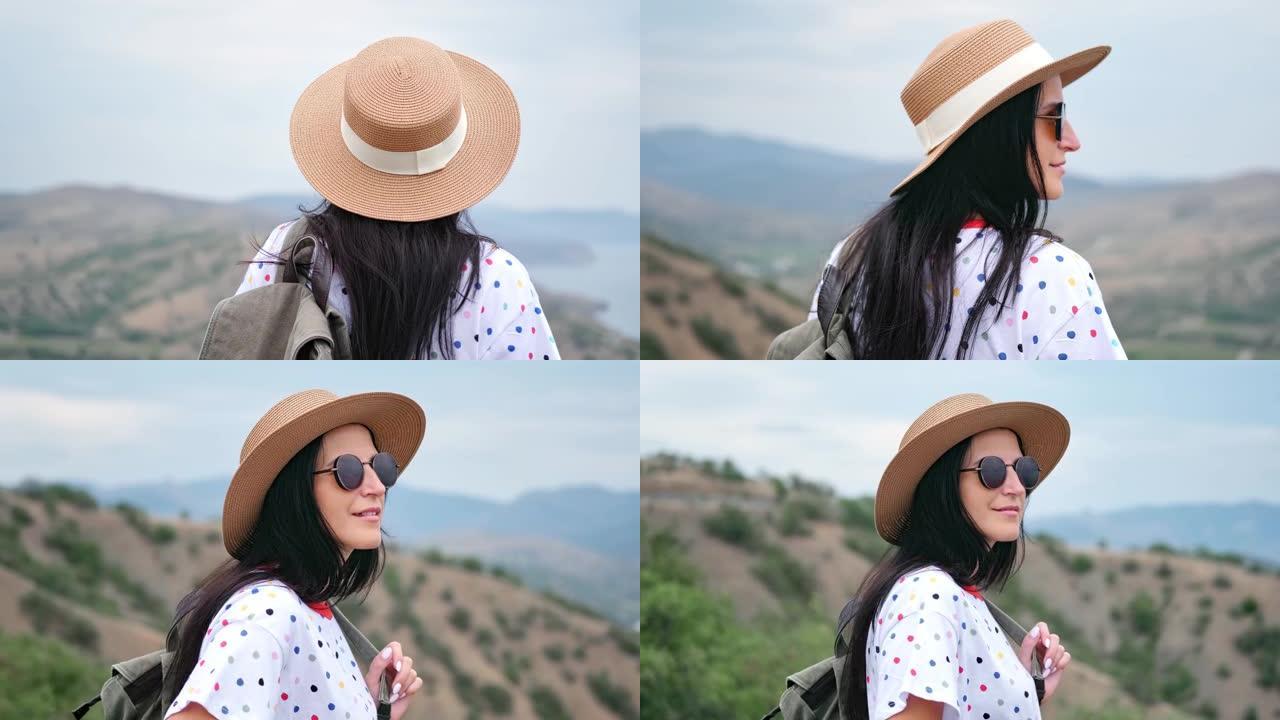 穿着草帽和太阳镜欣赏大自然的快乐旅行女孩的照片。4k龙红相机
