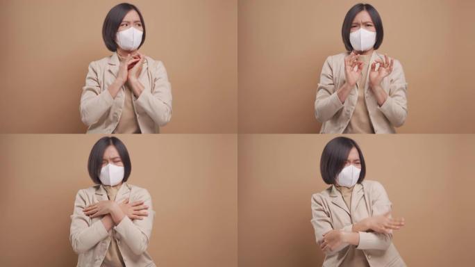 戴着卫生面具的亚洲女商人害怕和恐慌站在米色背景上孤立。4k视频