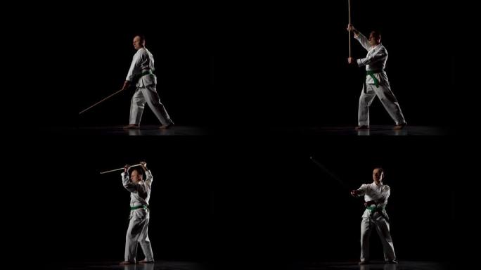 白色和服上的剑道战士在黑色背景上练习武术