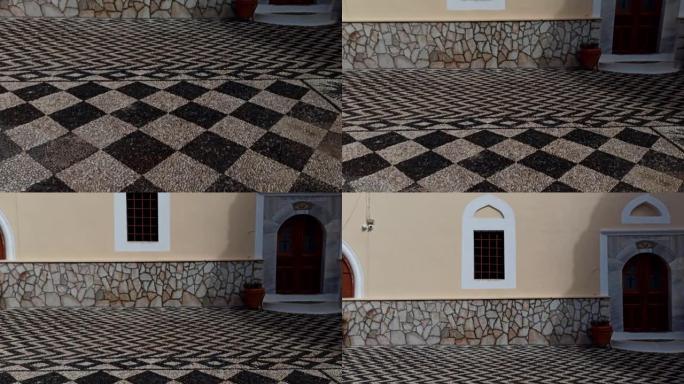 希腊罗德斯: 传统设计师地板的倾斜镜头和位于哈尔基/查尔基岛上教堂的入口