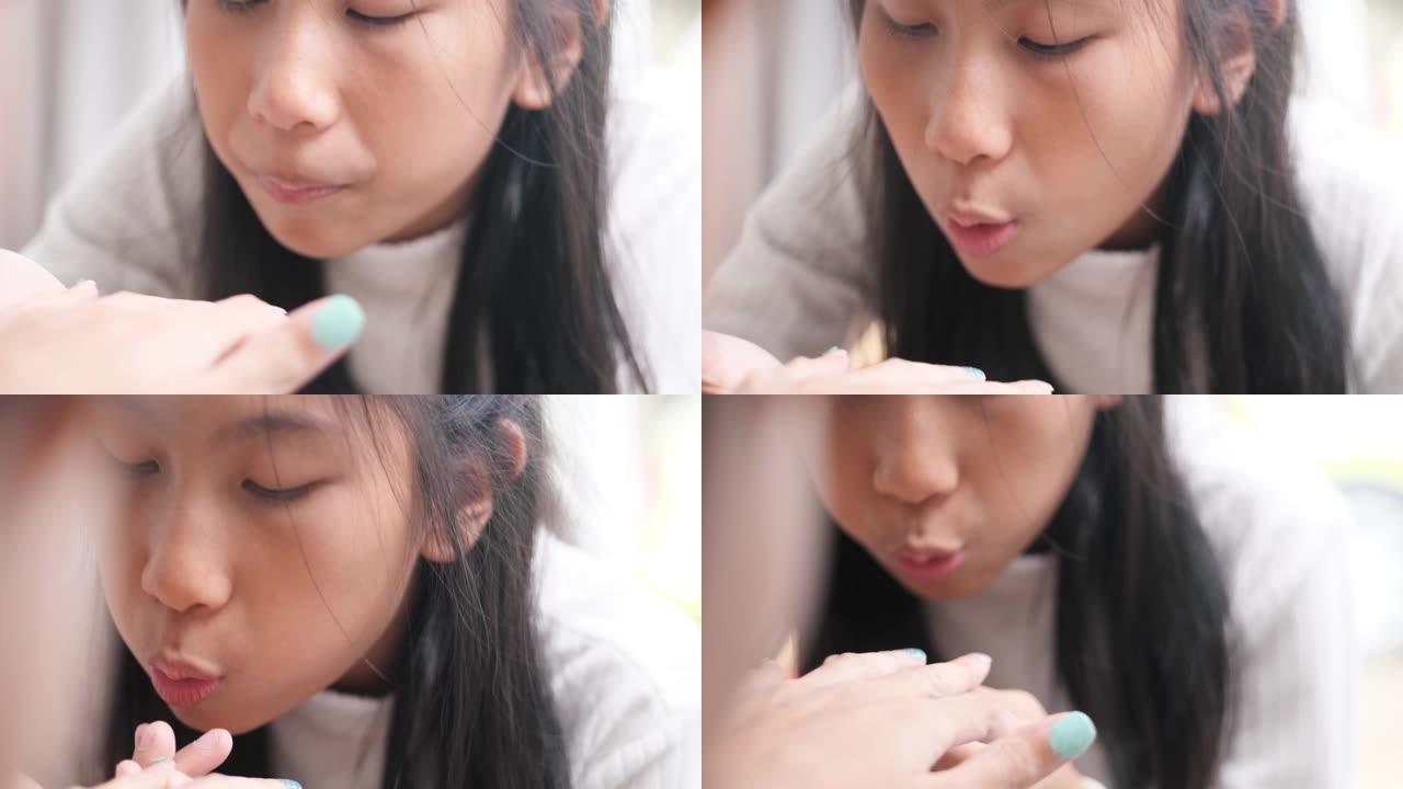 亚洲女孩画家妈妈手指指甲，一起放松。