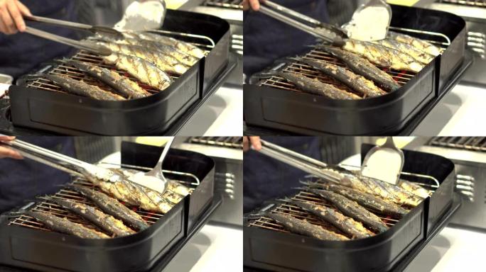 厨师烹饪烧烤鲭鱼或沙巴鱼