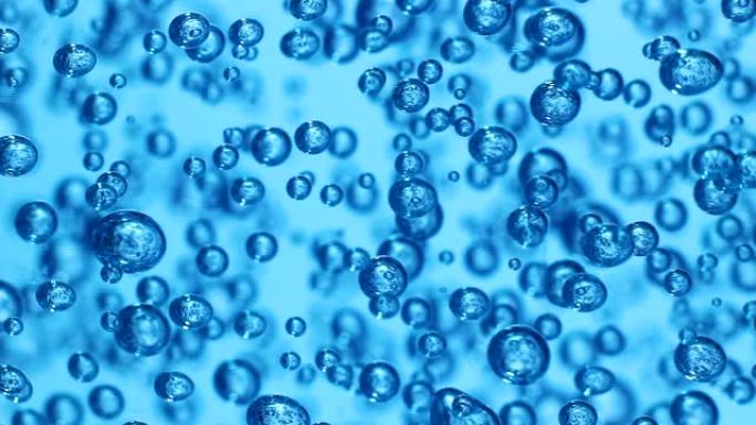 透明凝胶中气泡的宏观拍摄，蓝色背景。许多球体在浓液体中的运动