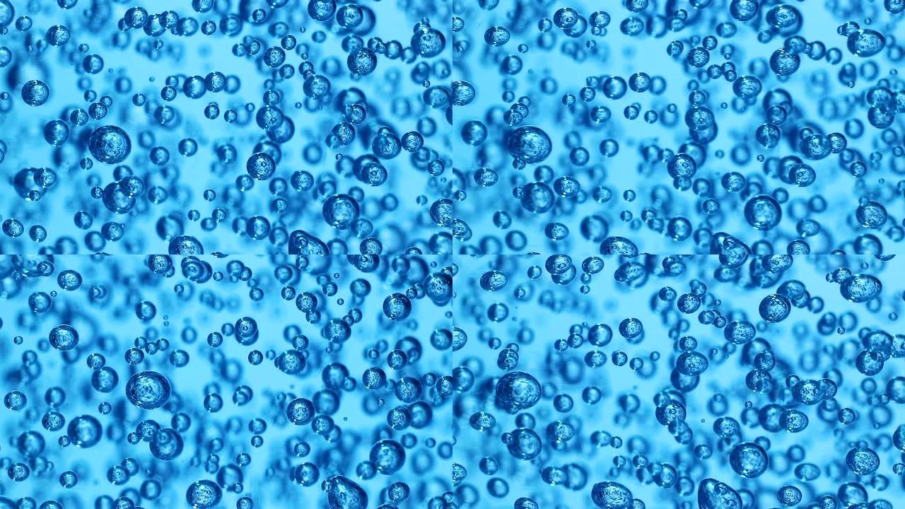 透明凝胶中气泡的宏观拍摄，蓝色背景。许多球体在浓液体中的运动