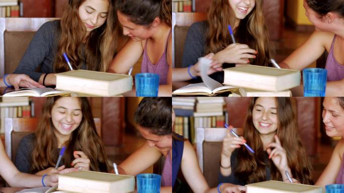 可爱的十几岁的女孩一起做作业，笑着玩得开心