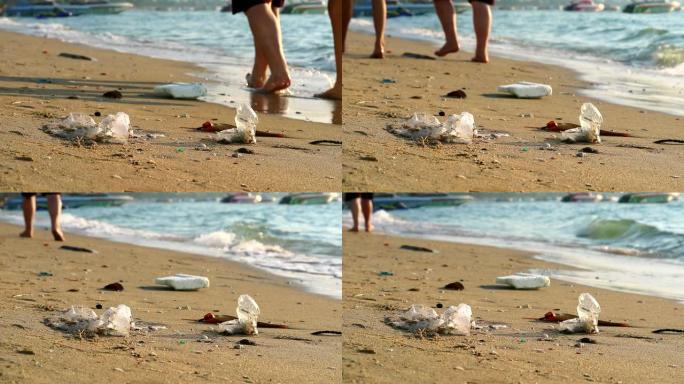 人们带着塑料橡胶在海滩上行走，废物留在海滩上，海浪把它们吹进海里