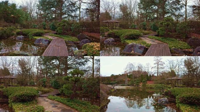 冬天穿过日本花园。木桥被扔过池塘
