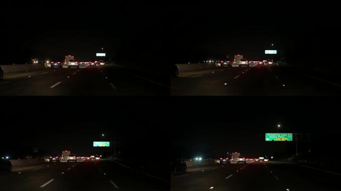 从车里看。洛杉矶夜间繁忙的高速公路。美国加利福尼亚州的大规模州际公路。在高速公路车道上快速行驶。交通