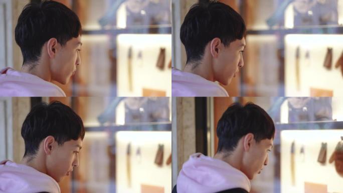 年轻的亚洲男子橱窗购物