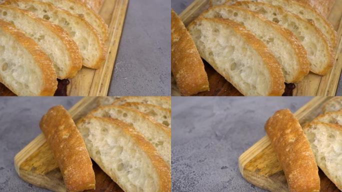 在灰色桌子上切成薄片的新鲜出炉的恰巴塔面包。