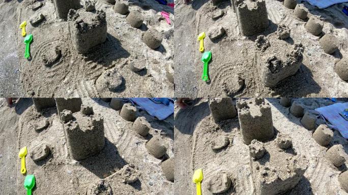在沙滩蓝海的南岸建造带有塔楼的房屋沙堡