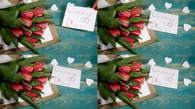 婚礼当天的信息和木桌上的郁金香花束的俯视图。夫妻关系概念。婚姻观念。4 k拍摄