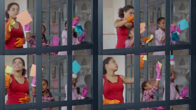 积极的黑人妈妈和孩子清洁窗户玻璃