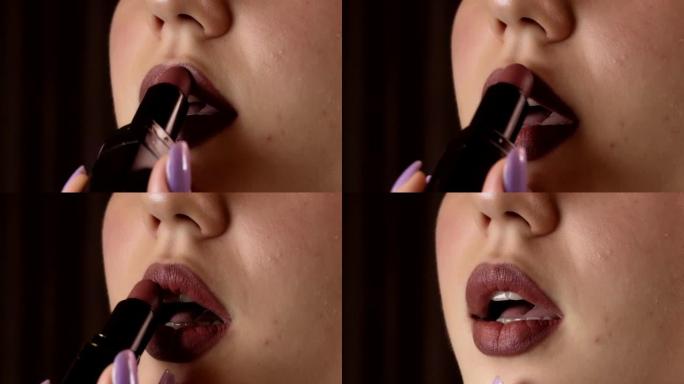 女孩把口红涂在嘴唇上。专业化妆。