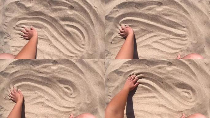手在沙子表面移动，俯视图。男人的手散射
