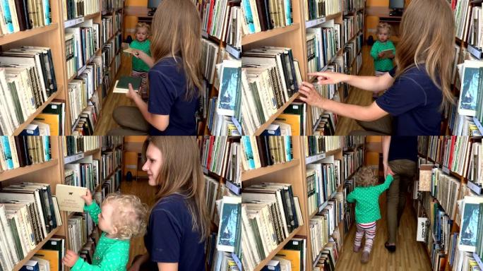 学生妇女在图书馆为她的小女儿女孩选书。