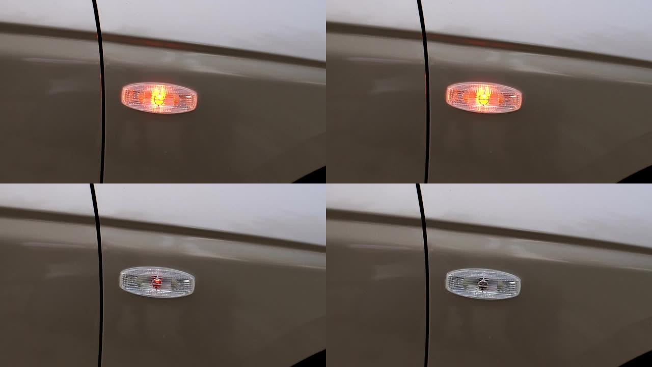 汽车上闪烁的黄色前灯的特写，特写。慢动作。