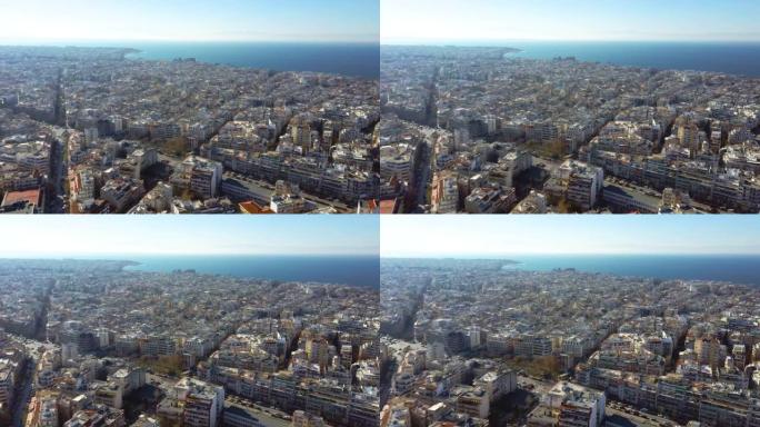 带有建筑物的城市环境的鸟瞰图，带有蓝色大海的城市海岸，塞萨洛尼基希腊，无人驾驶飞机前进