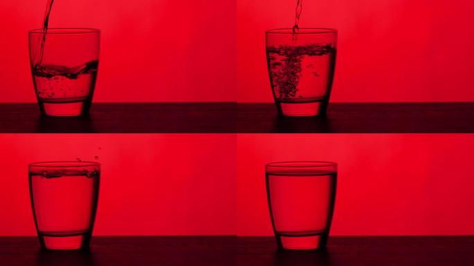 倒杯水-红色背景倒入透明玻璃杯水源