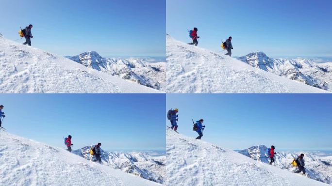 高山登山队冬季在高海拔山峰上连续行走