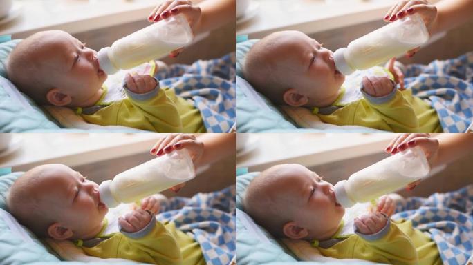 女人从瓶子里喂婴儿牛奶