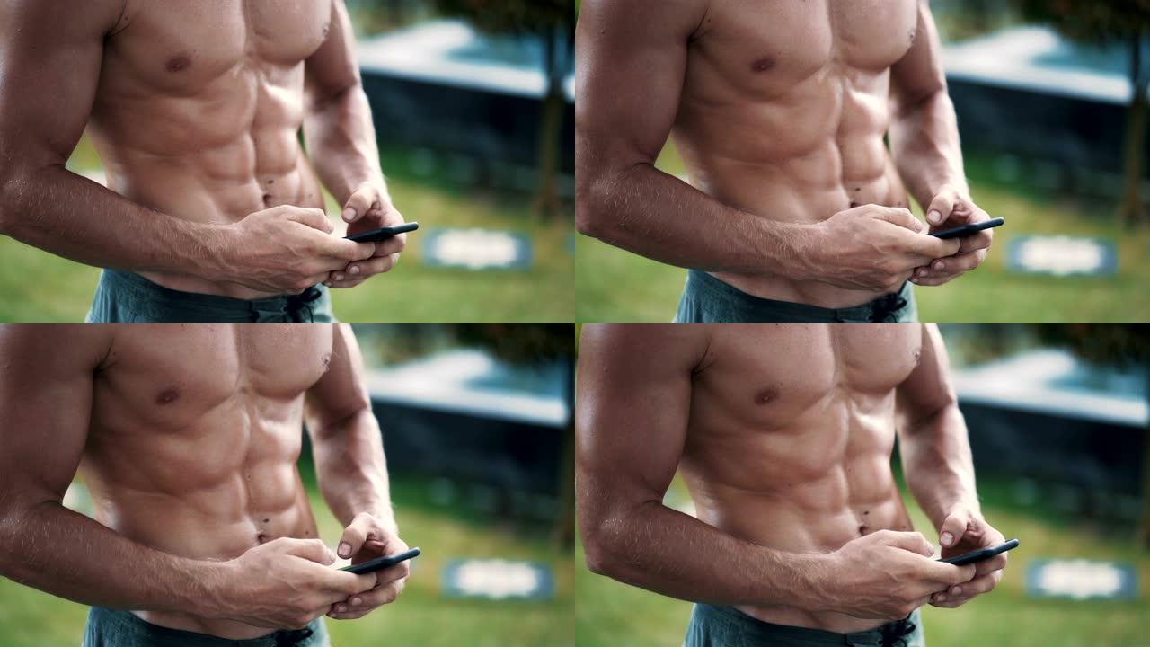 近距离看，赤裸上身的肌肉男正在用手机发信息