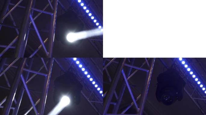 带有白色光束的照明装置在舞台上移动