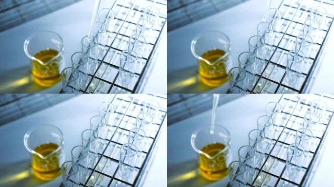 科学家在实验室实验中将化学溶液滴入试管中。化学和石油概念