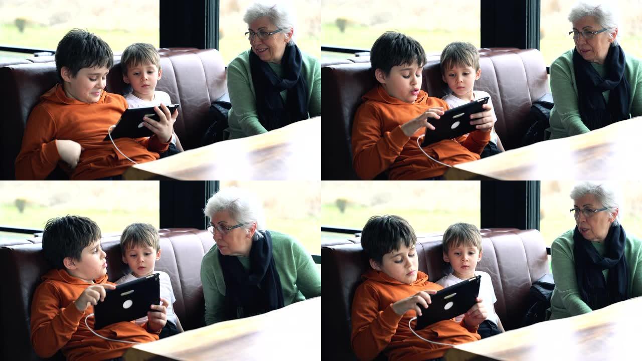 祖母和孙子在咖啡馆里寻找数字平板电脑