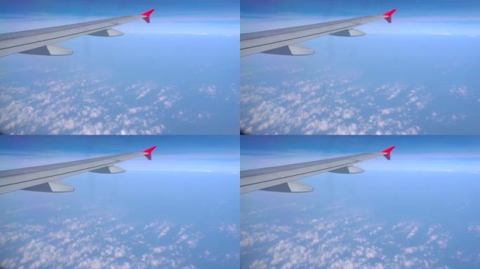 飞机飞行。飞机的翅膀在日落天空的云层上飞行。从飞机的窗户看。飞机。乘飞机旅行。4K超高清视频