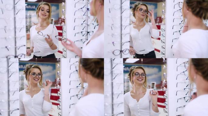 美女在镜子前试戴新眼镜。