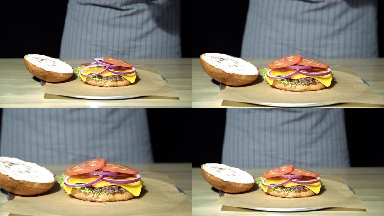 厨师准备汉堡的手的特写镜头。