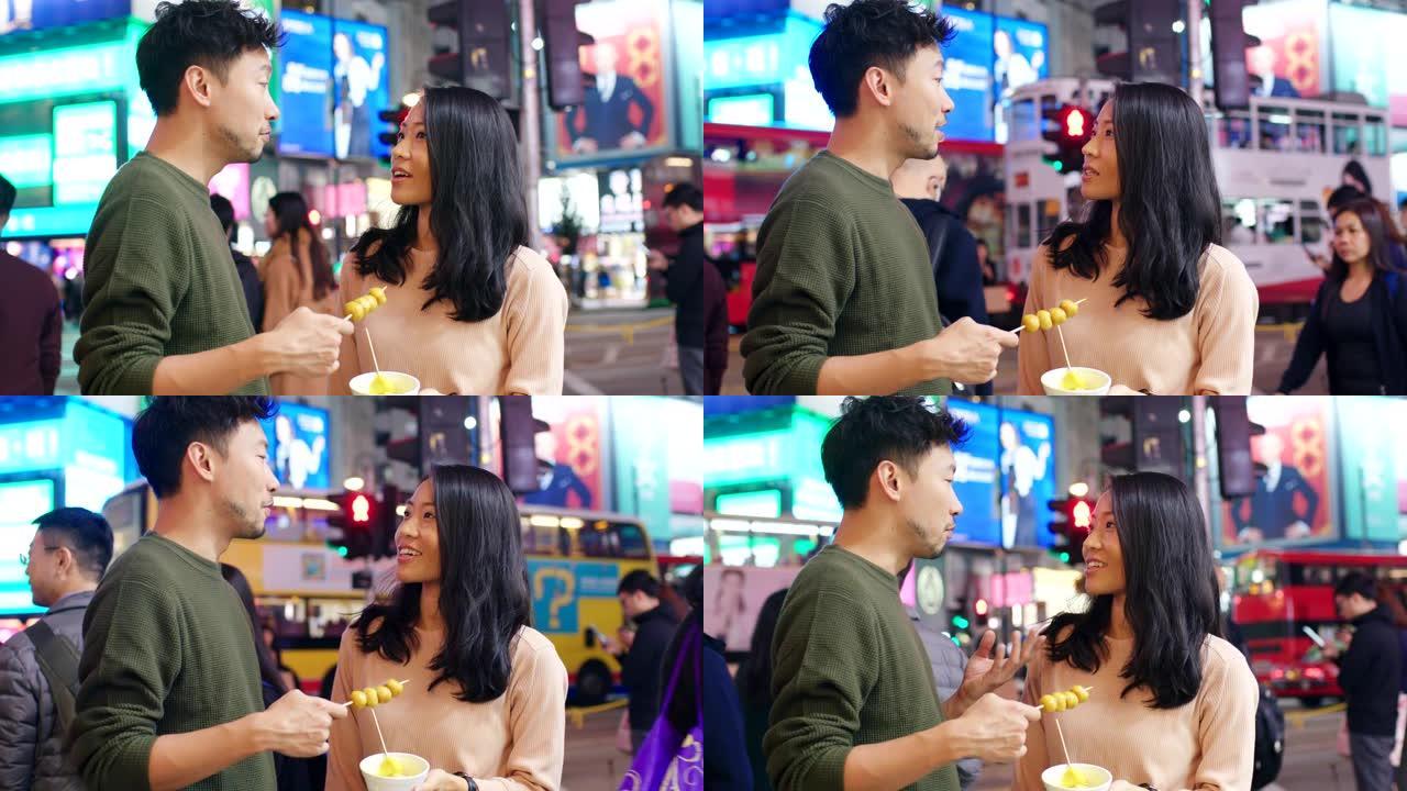 SLO MO掌上电脑拍摄了一对年轻夫妇在吃街头美食的镜头