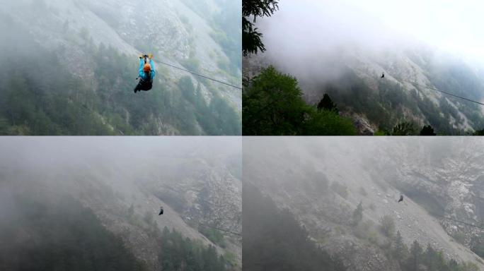 年轻的女人正沿着2019黑山的云层中的山脉和大海中的滑索。