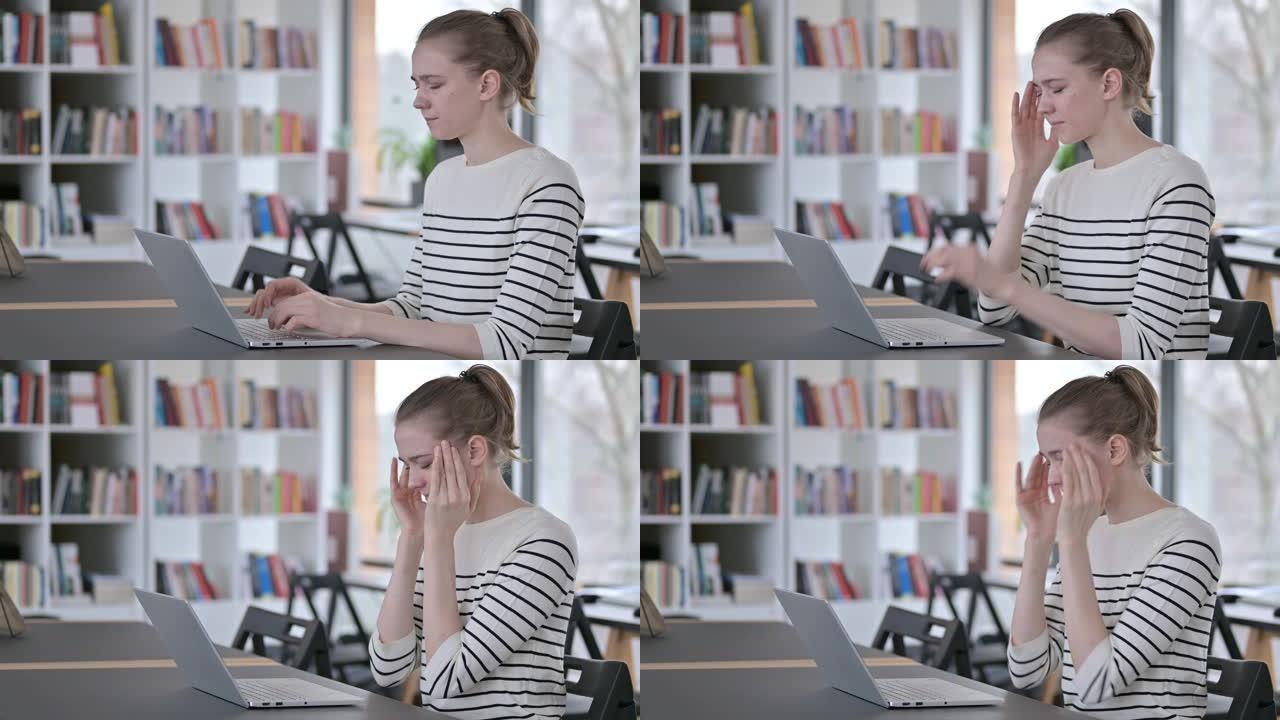 图书馆头痛的年轻女性使用笔记本电脑