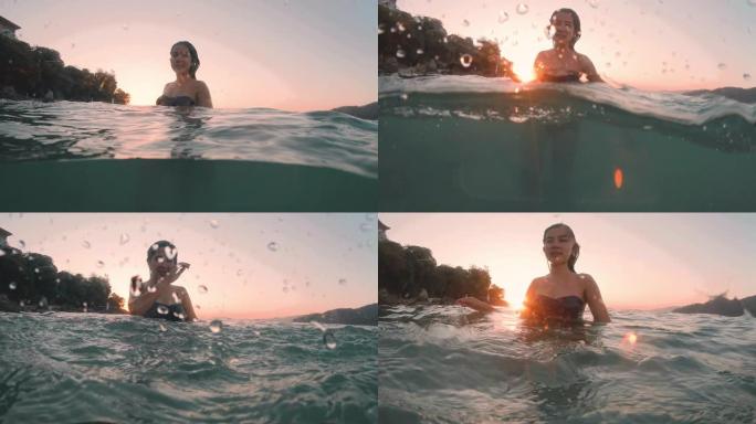夏天的亚洲女人在水下嬉水和放松日落