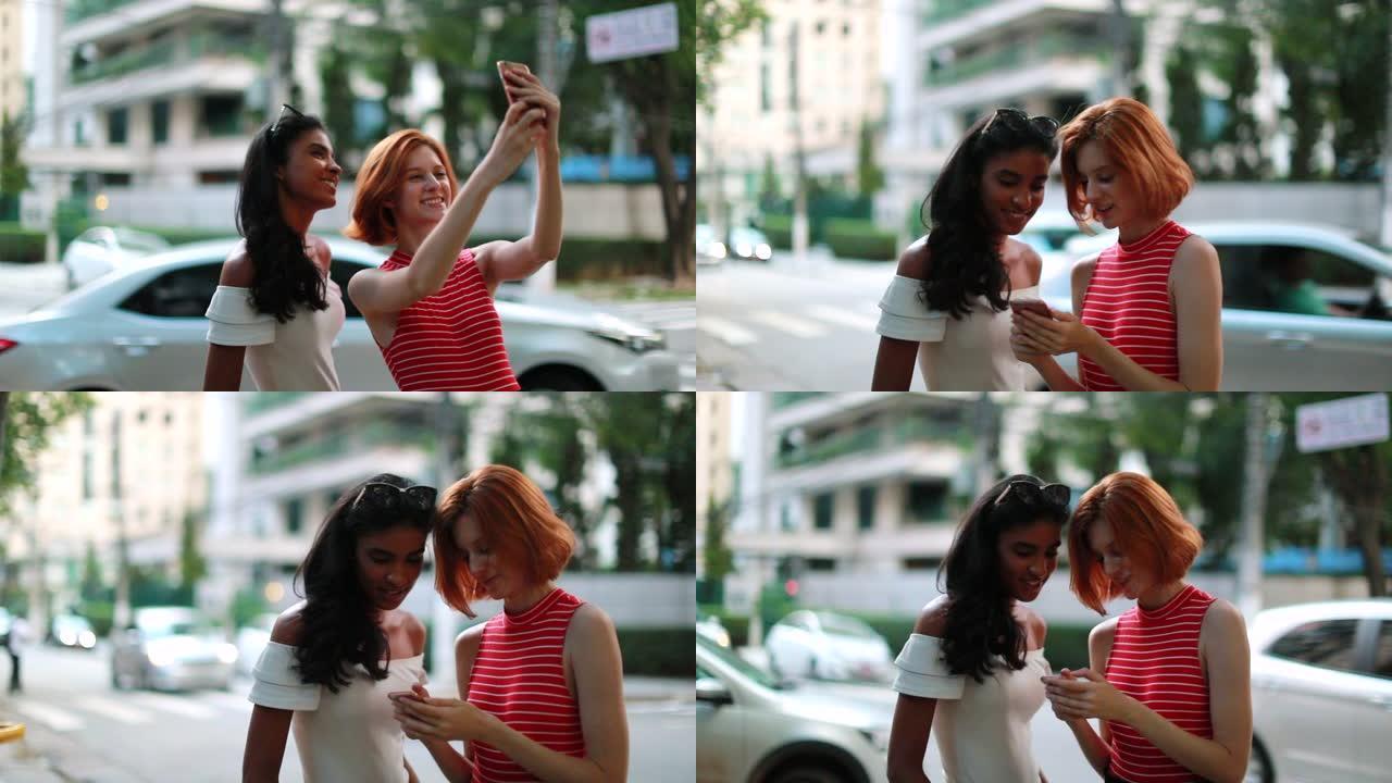 两个漂亮的多种族朋友在街上自拍。多民族女友拍照