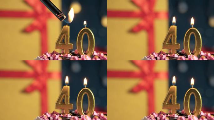 生日蛋糕40号点火器燃烧的金色蜡烛，蓝色背景礼物黄色盒子用红丝带绑起来。特写和慢动作