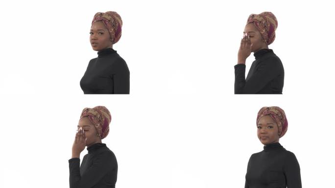 千禧一代的女人闲聊。一位非洲年轻女子窃窃私语并用手遮住嘴的特写肖像。肢体语言